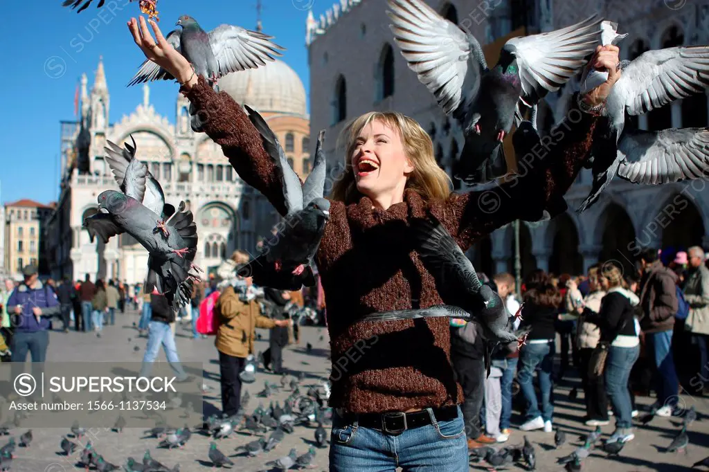 29 year old woman with pigeons in St Mark´s Square, Venice  Veneto, Italy