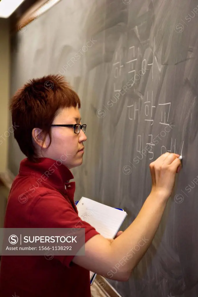 Asian graduate student at blackboard
