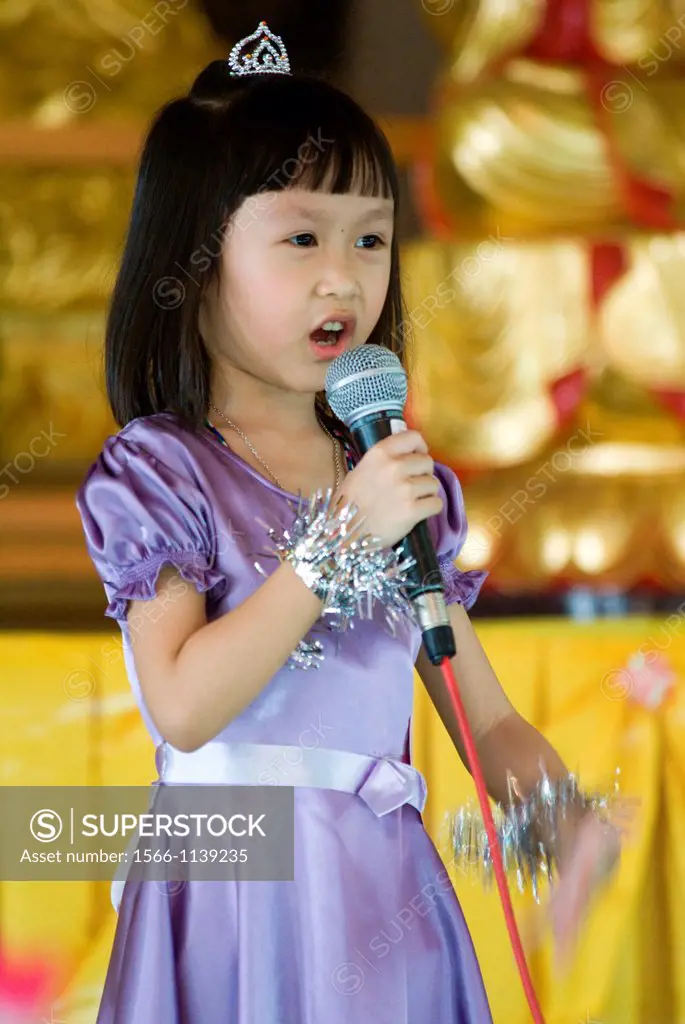A girl singing on stage at Kindagarden Karaoke Competition.