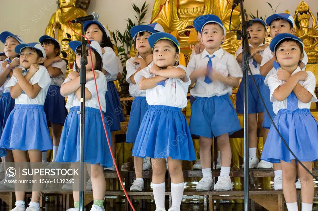 A group of children singing on stage at Kindagarden Karaoke Competition.
