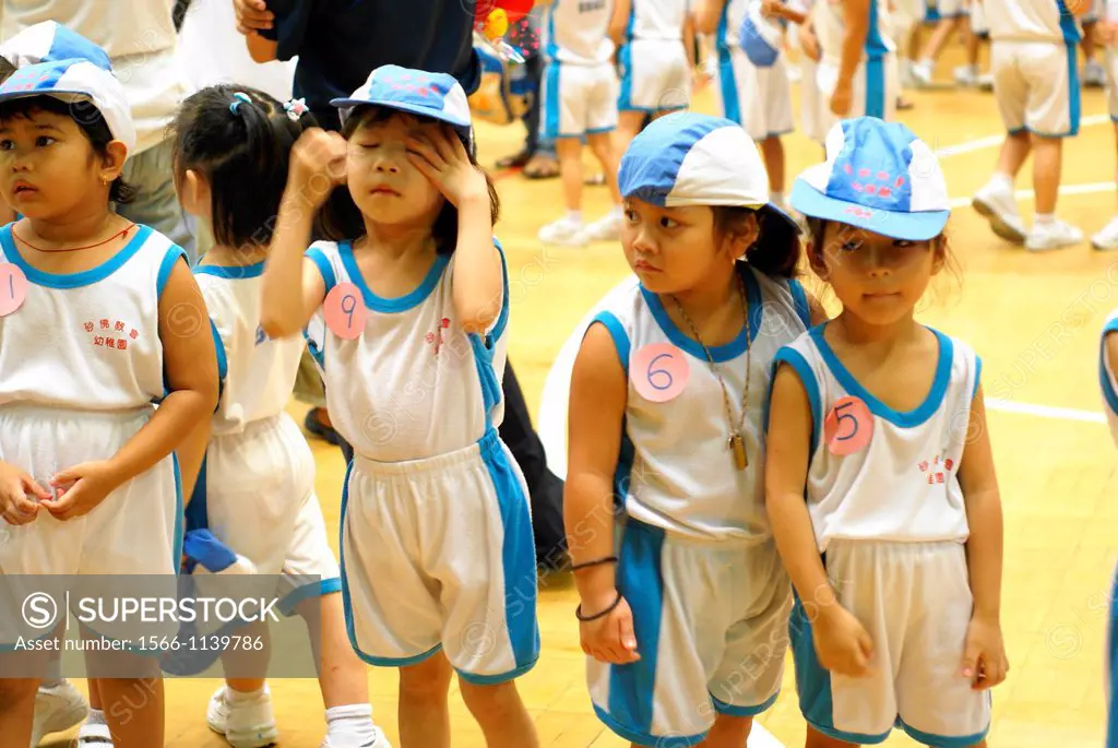 A group of children and teachers playing game at SBA Kindagarden Sports day.