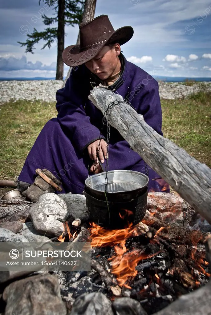 young nomad preparing a campfire, Khovsgol, Northern Mongolia