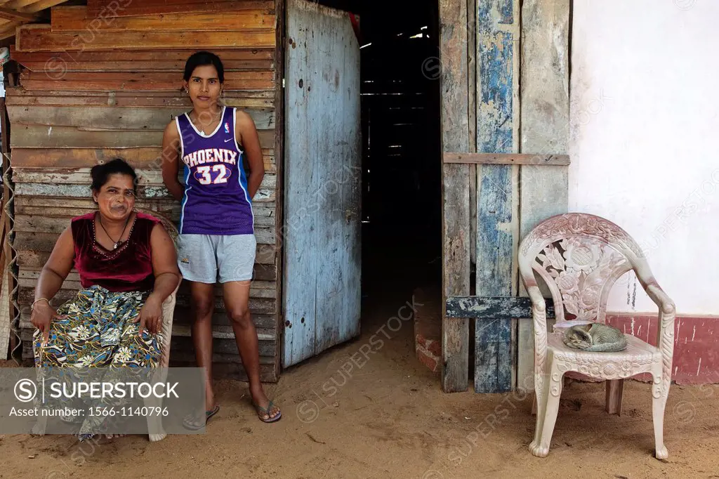 Mother and daughter sitting outside their house in Waikkal village, Sri Lanka