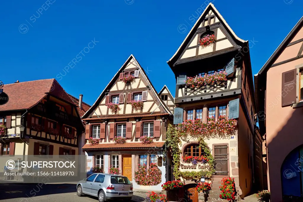 France,Alsace,Bas-Rhin (67),Wine Route,Dambach town,facade of two houses,tavern (Martz) and cottage,windows with flowers.