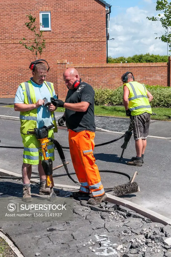 construction workers mending pavement,cleveleys,lancashire,england,uk,europe