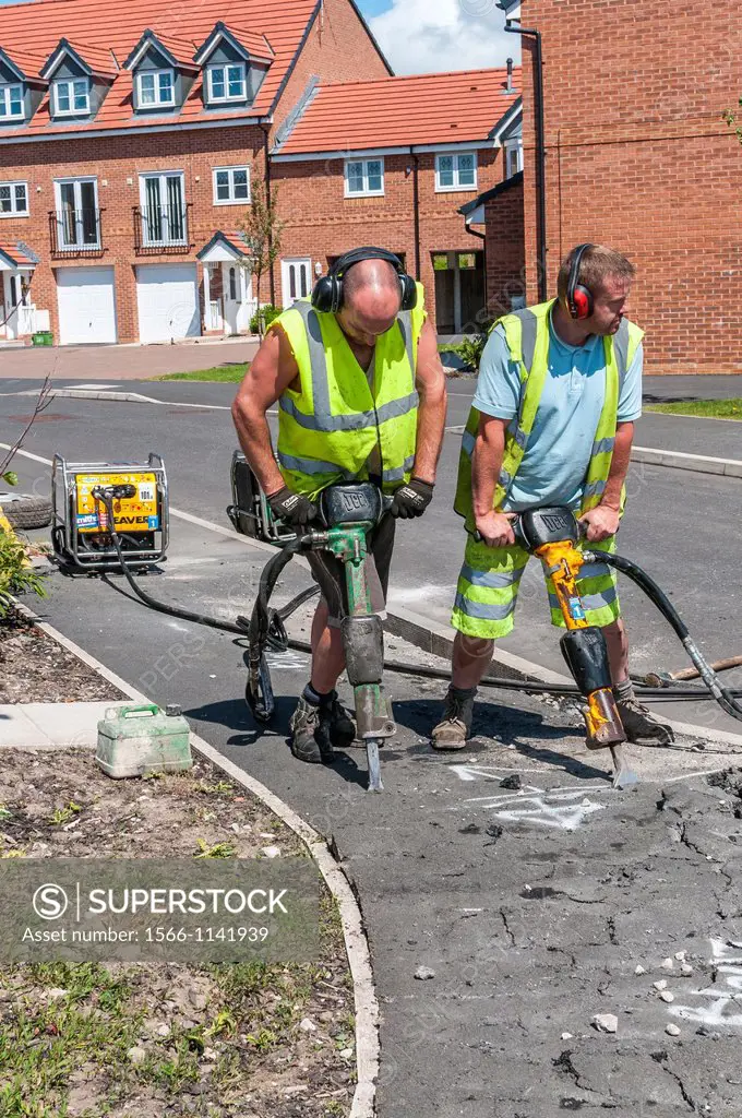 construction workers mending pavement,cleveleys,lancashire,england,uk,europe