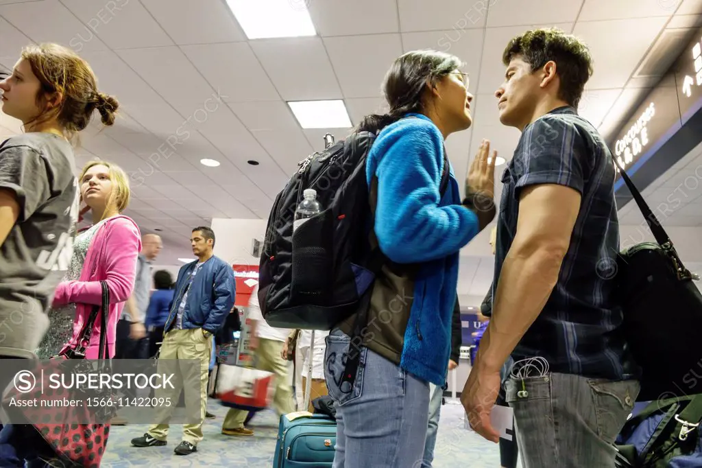 California, CA, Los Angeles, LAX, international airport, terminal, gate, Asian, woman, man, couple, young adults, relationship, face to face, talking,...