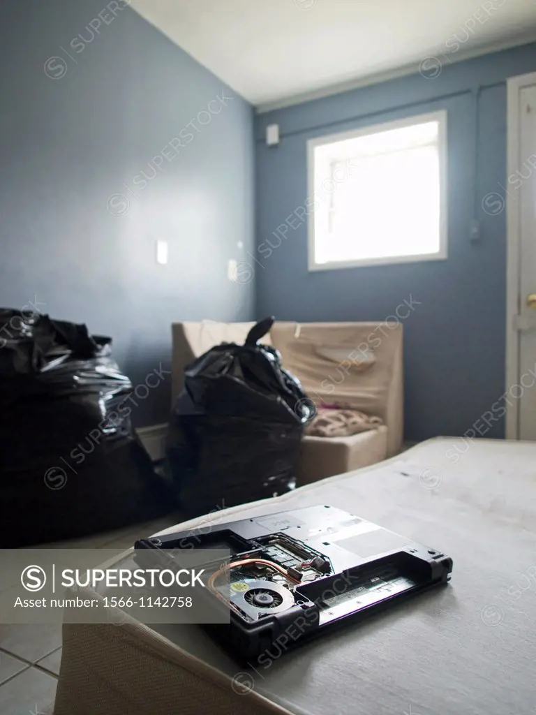 A broken VHS tape sits on a matress in a blue room inside a foreclsoed house in the Bronx, New York, New York