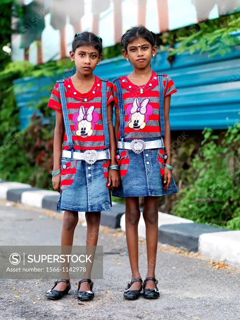 Indian Malaysian twins dressed in identical clothing