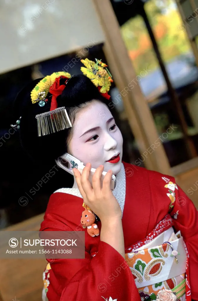 A Maiko, or Geisha in training, talks on the phone
