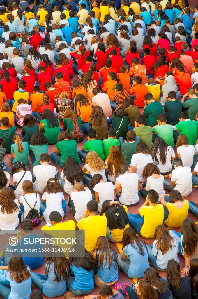 Young people wearing shirts of different colors.