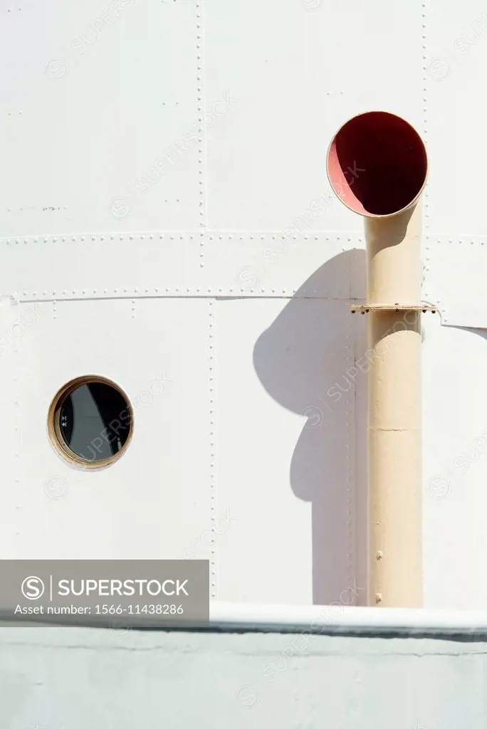 Ventilator and porthole on white ship.