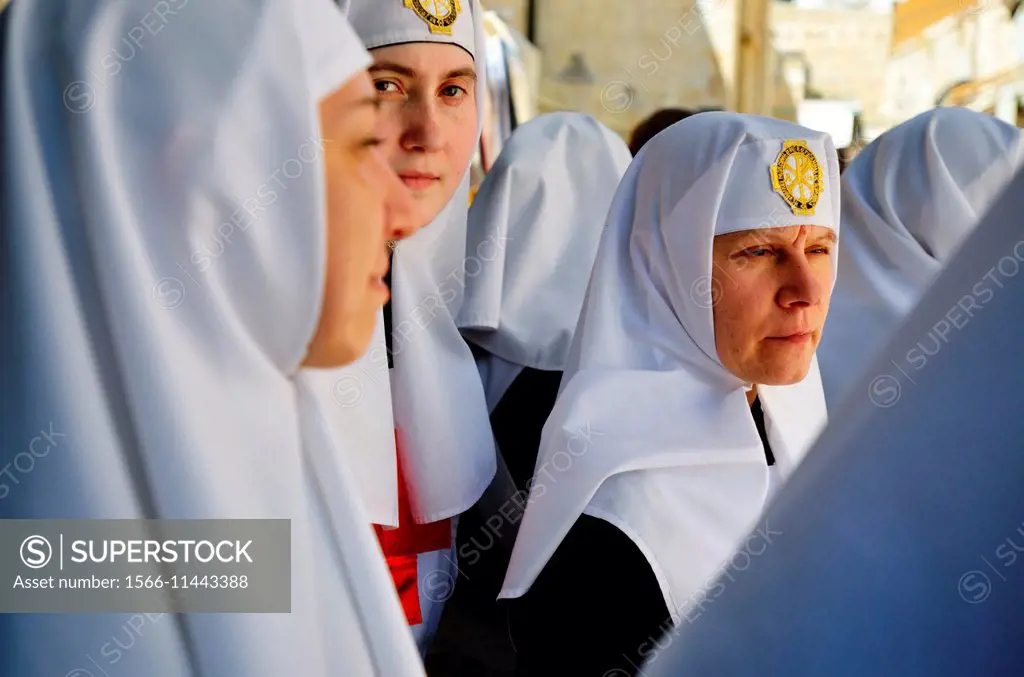 Eastern Orthodox nuns hold flowers during a Good Friday procession near the Church of the Holy Sepulchre in the Old City of Jerusalem, Israel.