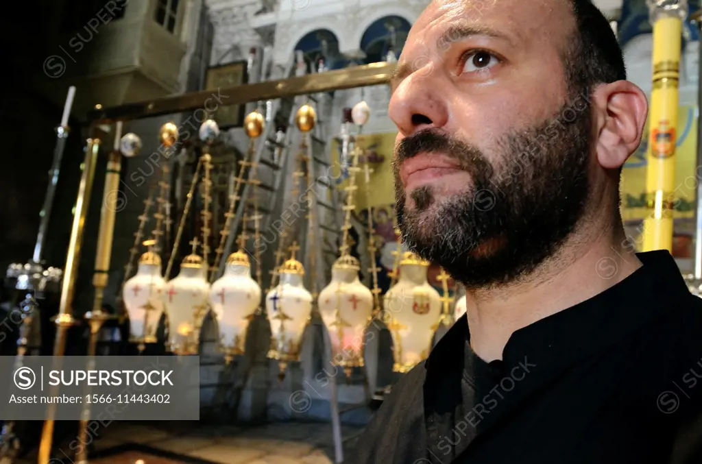 Christian Orthodox priest in the Church of Holy Sepulchre on Good Friday in Old Town of Jerusalem; Israel.