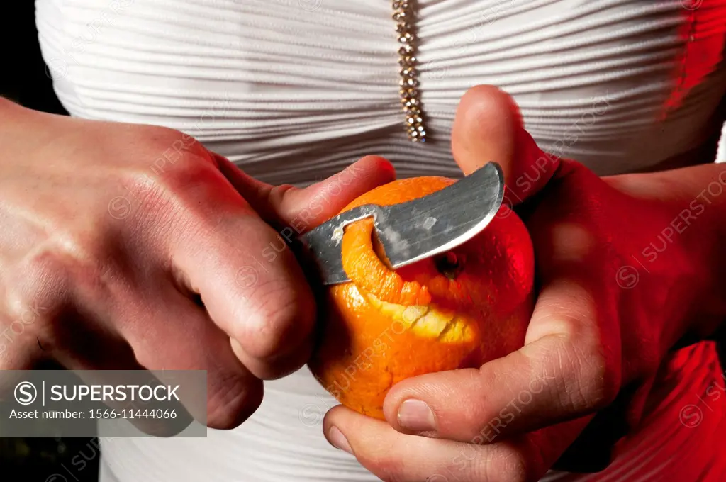woman peeling an orange for a cocktail