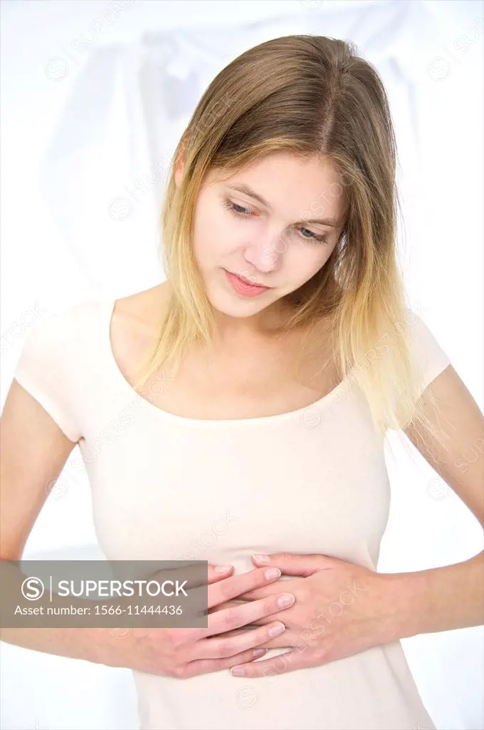 young beautiful blond girl holding and massaging her painful stomach