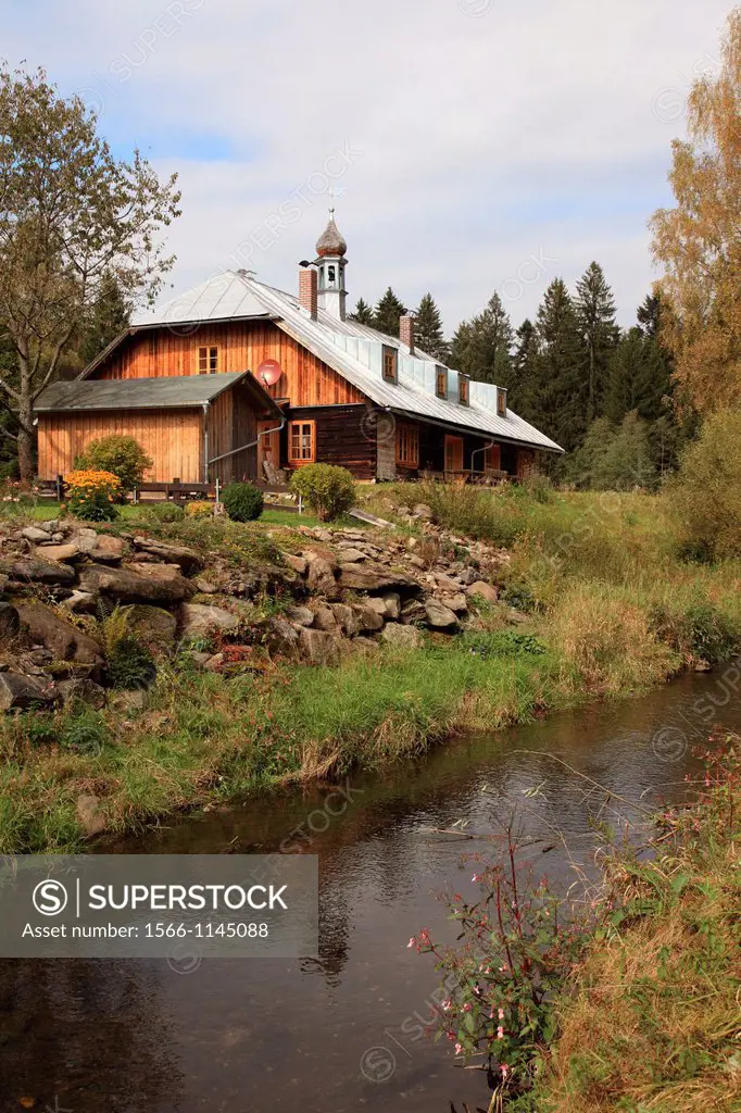 restored old wooden house built in typical Bohemian style near the Czech border at the foothills of the mountain Great Arber at Bayerisch Eisenstein, ...