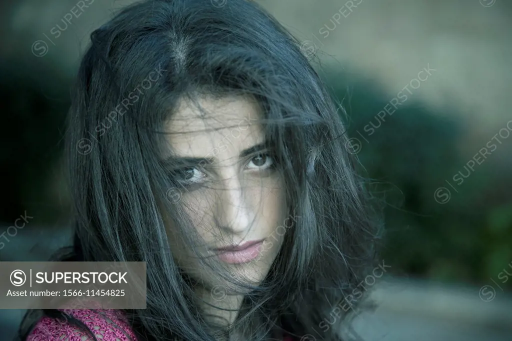 Young woman hair vcovering face.