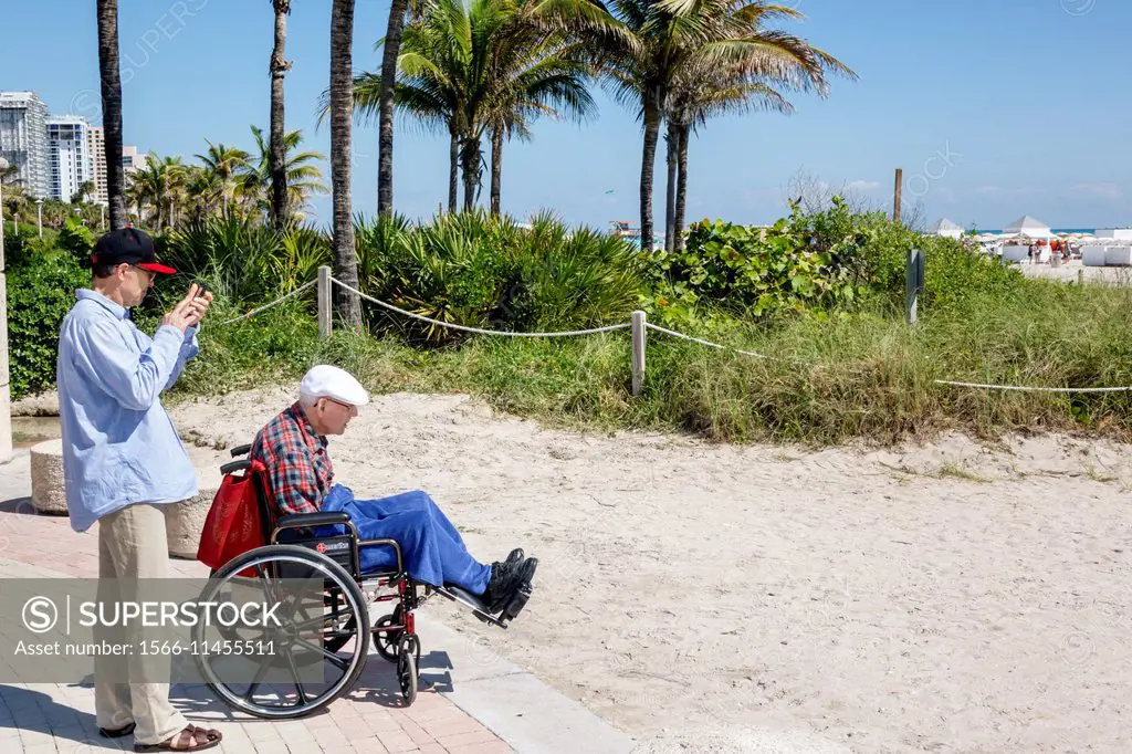 Florida, Miami Beach, man, adult son, senior, elderly, wheelchair, old.