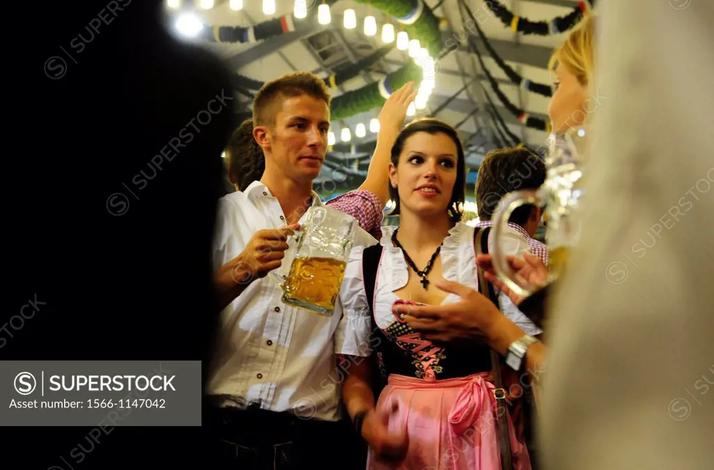 People celebrate and drink beer during the opening day of the Oktoberfest in Munich,Germany