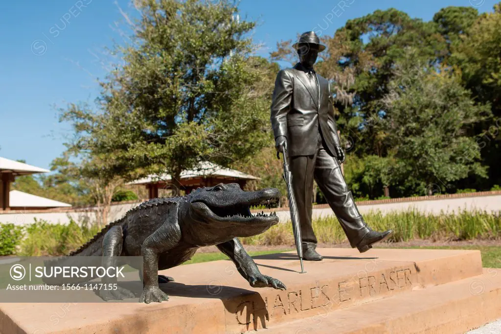 Statue of Charles E  Fraser walking an alligator in Compass Rose Park on Hilton Head Island, SC