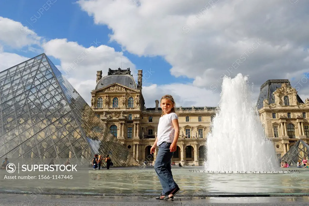 little girl walking on the edge of the pond surrounding the Louvre Pyramid in the main courtyard Napoleon of the Louvre Palace, Paris, Ile-de-France r...