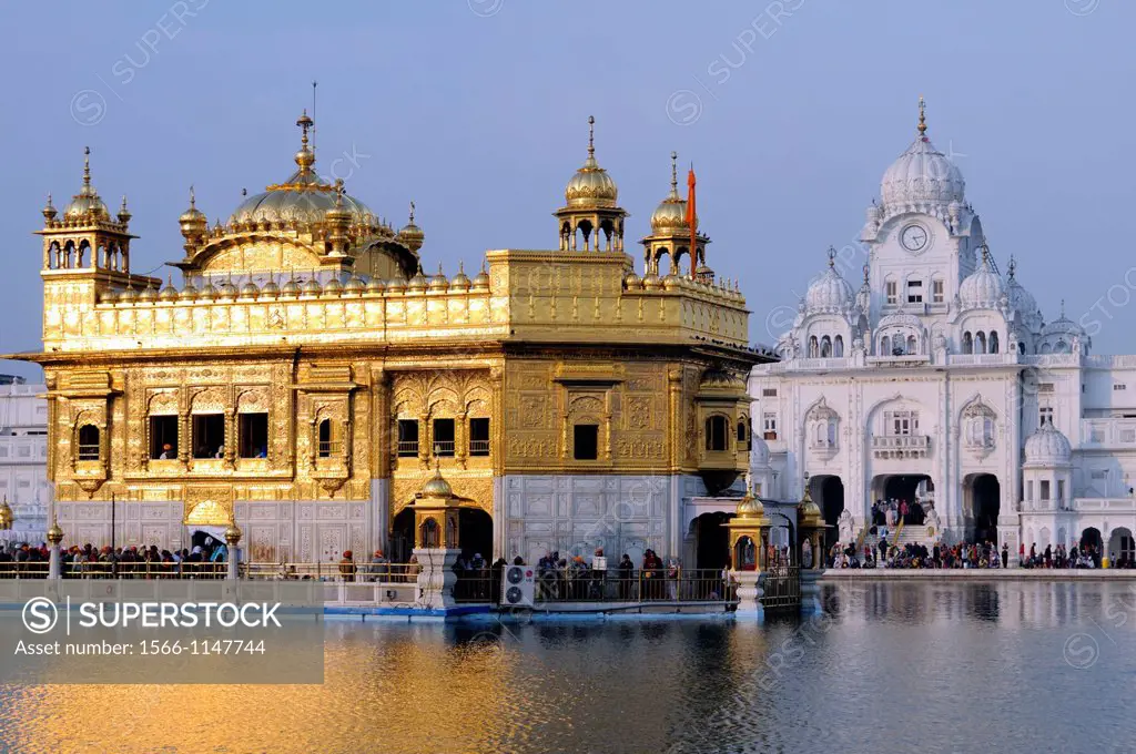 India. Punjab. Amritsar. The Golden Temple. The Sri Harmandir Sahib the holy of holies of Sikhism, hindu-islamic style. To the left the Victorian towe...