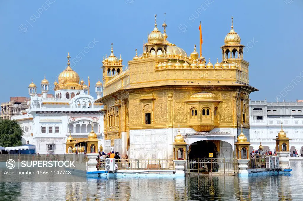 India. Punjab. Amritsar. The Golden Temple. The Sri Harmandir Sahib the holy of holies of Sikhism, hindu-islamic style. On the left the Darshani Deohd...