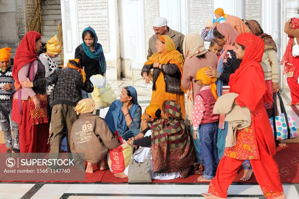 India. Punjab. Amritsar. The Golden Temple. Sikh believers resting on the Parikrama Marble Path.