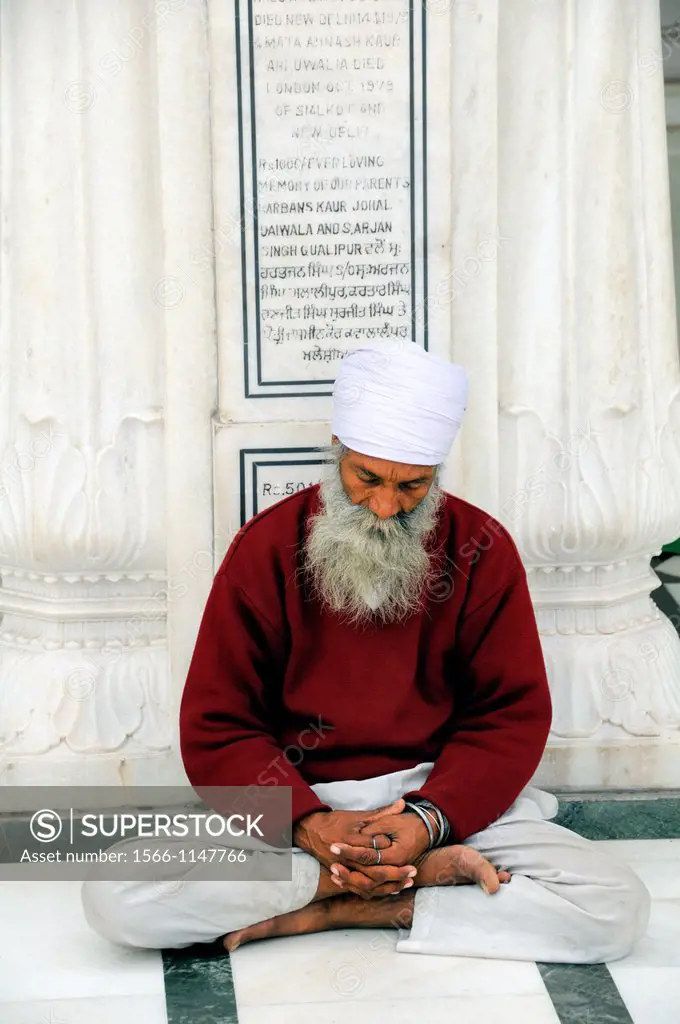 India. Punjab. Amritsar. The Golden Temple. Sikh believer meditating.