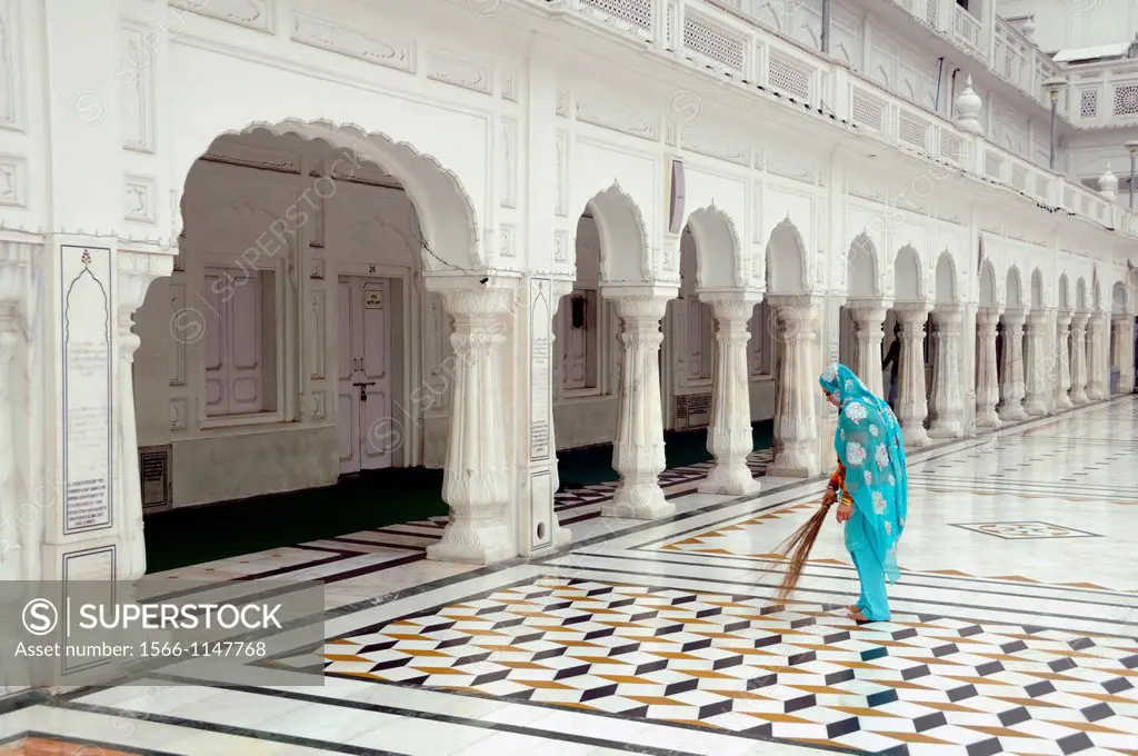 India. Punjab. Amritsar. The Golden Temple. Clearing the Parikrama Marble Path.