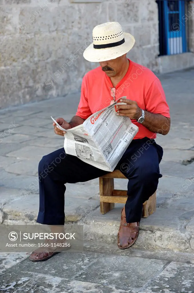 Man reading newspaper in Havana,Cuba