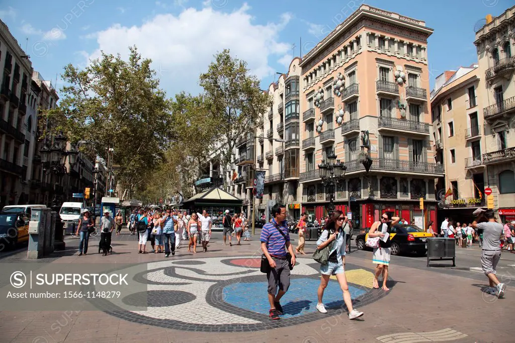 Tourists and pedestrians walking down La Rambla with mosaic by Joan Miro, Barcelona, Catalonia, Spain, Europe.