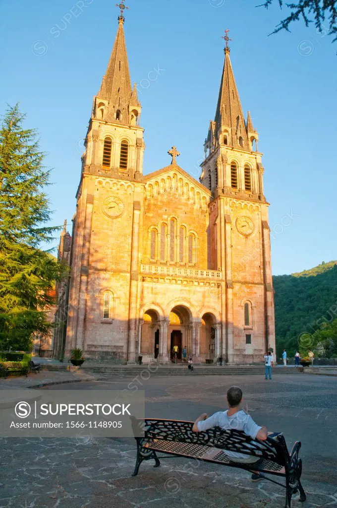 Man sitting on bench, next to the basilica. Covadonga, Asturias province, Spain.