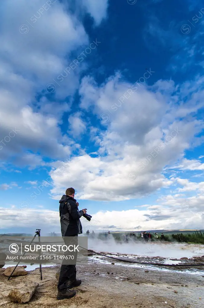 Photographer in Geysir area, Hot springs, Iceland