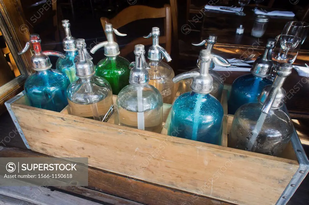A case containing old fashioned bottles of seltzer is seen outside a restaurant in New York