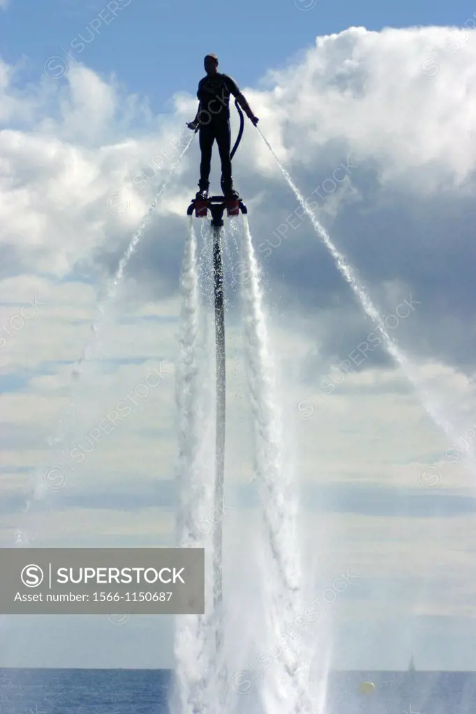 Man practicing flyboard new water sport in Barcelona, during Festa al cel Airshow 2012