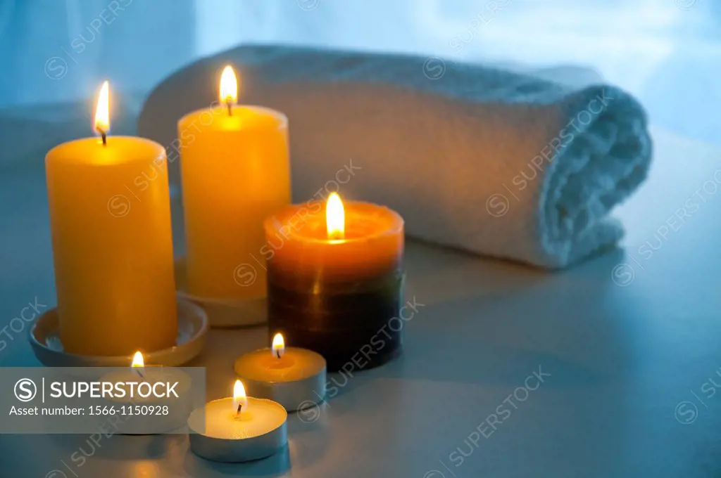 Lit up candles and towel