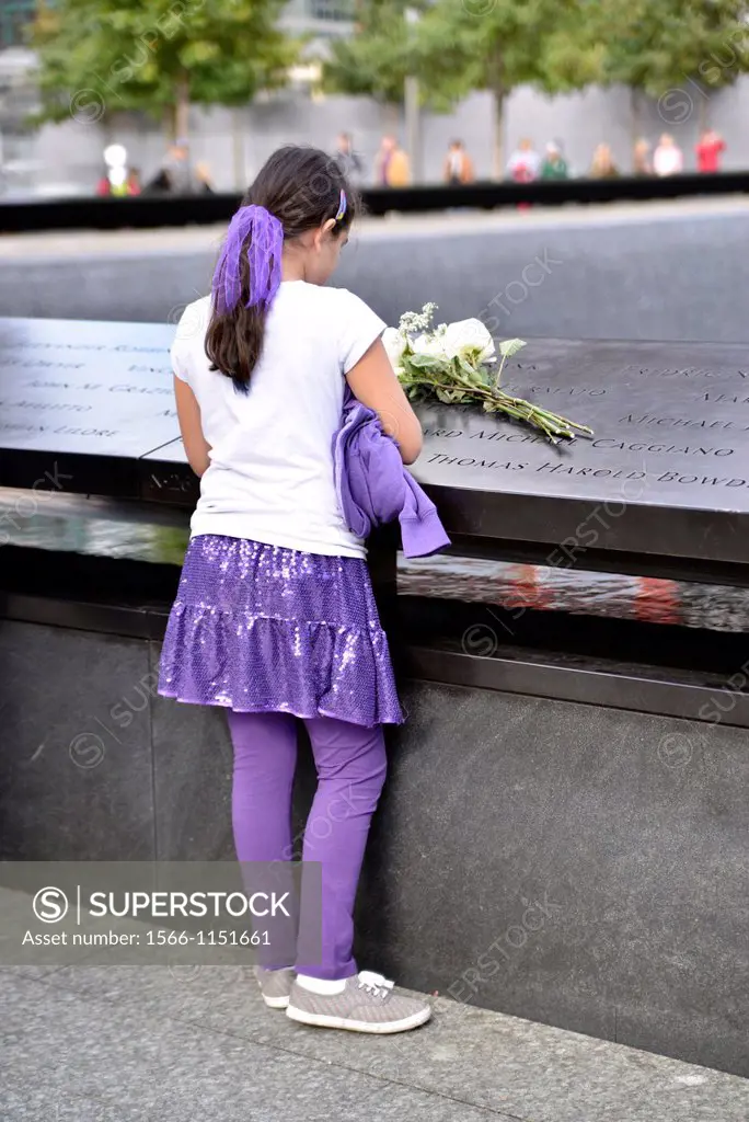 Girl, 9-14, Placing a Bouquet of White Roses on a Specific Name on the Memoria Plaque, World Trade Center, 9/11 Memorial, New York City, USA