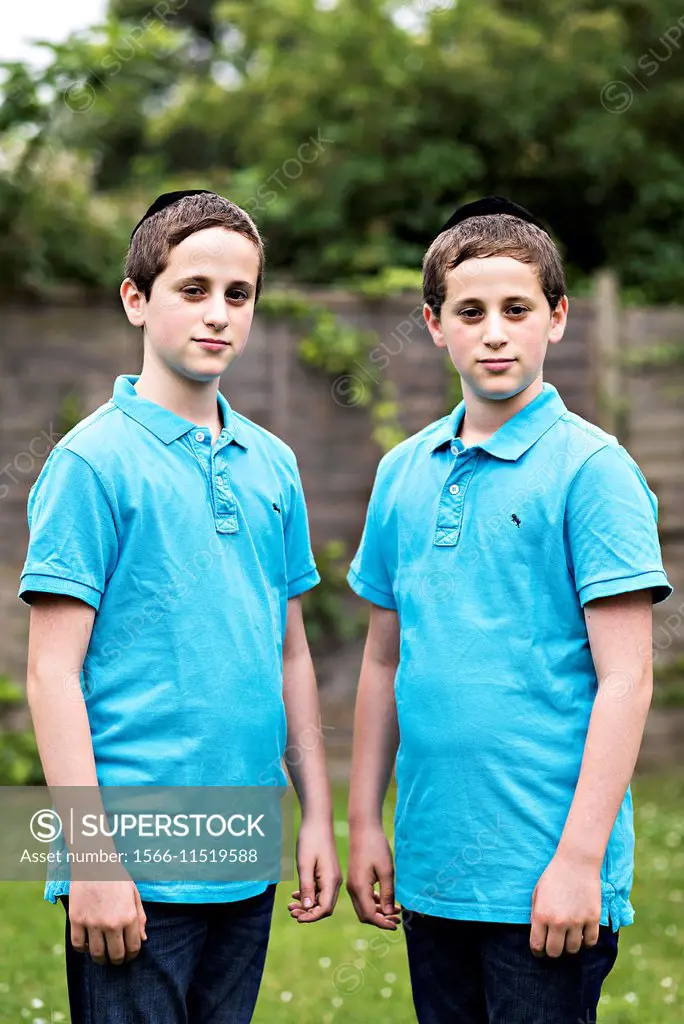 Young twin brothers in their back garden.