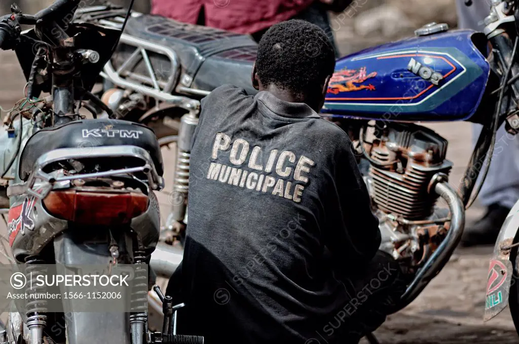 Mechanic fixing motorbikes in the streets of Bamako, Mali