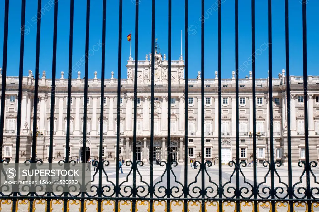 Royal Palace viewed through the iron fence. Armeria Square, Madrid, Spain.