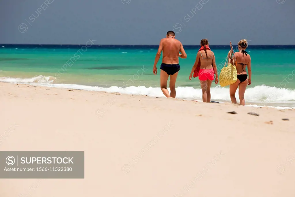 Tourists walking on Sotavento beach, Fuerteventura, Canary Islands, Spain, Europe.