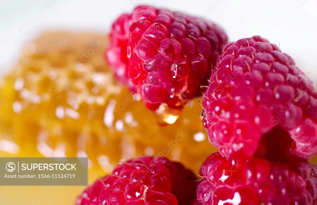 close up of raspberries and honeycomb.