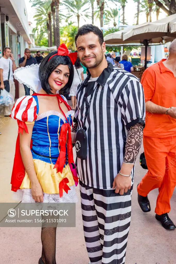 Florida, Miami Beach, Lincoln Road, pedestrian mall, Halloween, costume, wearing, outfit, character, Snow White, prisoner, stripes, man, woman, couple...