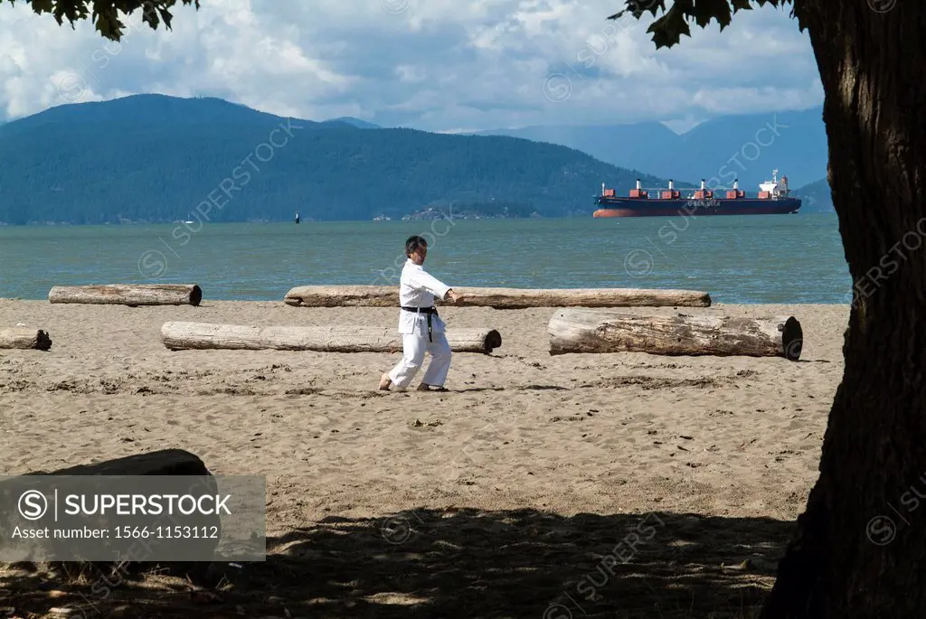 a man practices martial art at Locarno Beach in Vancouver, BC, Canada