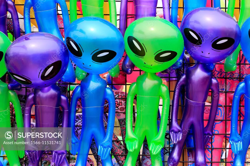 Little green men martian alien dolls displayed at a county fair as prizes for games played on the midway