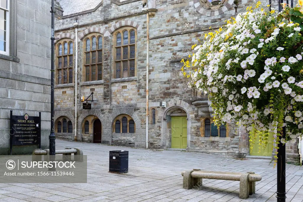 square in Bodmin town center, Cornwall, view of flowers and stone buildings in square of small town in Cornwall countryside.