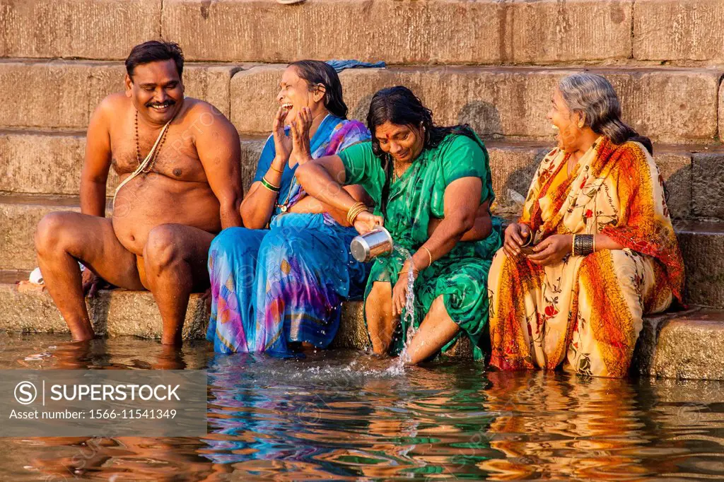 Women take a religious bath to clean their souls from past sins in the holy  river Ganges in the city of Varanasi in northern Ind Stock Photo - Alamy