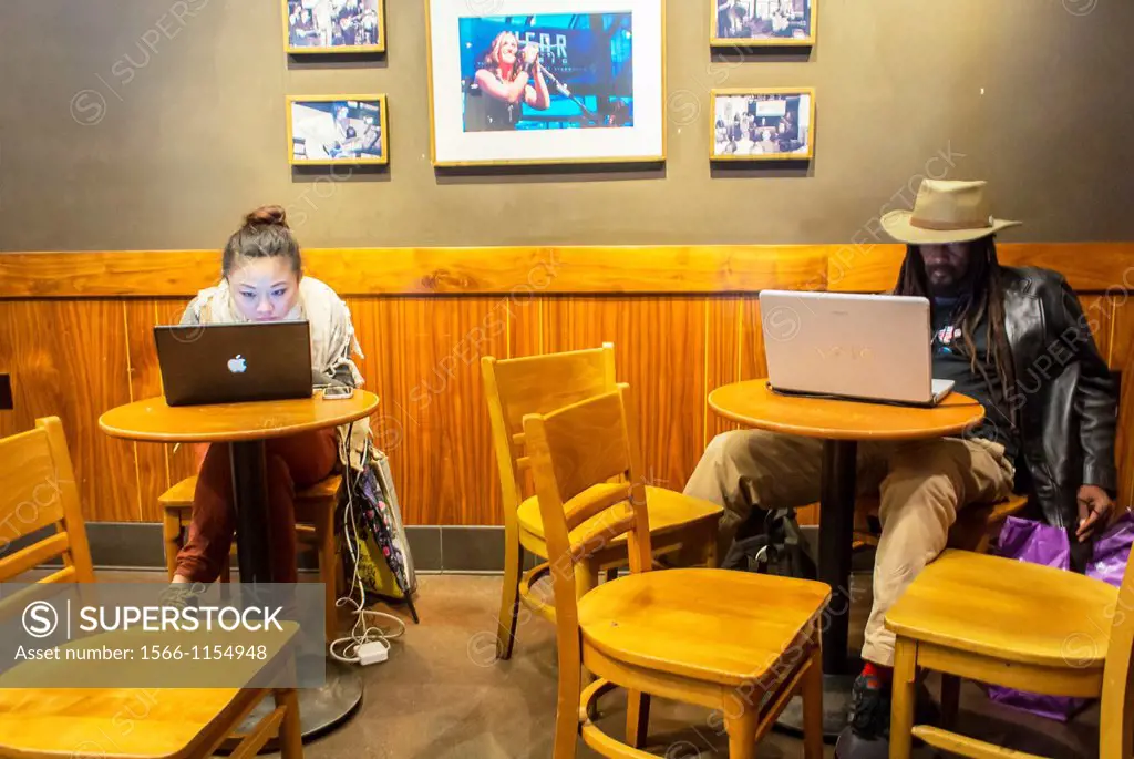 New York City, NY, People Using Free Wifi Connection inside Starbuck´s Coffee Shop in the East Village, Manhattan